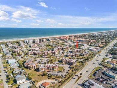 Aerial overview of property's location featuring expansive beach