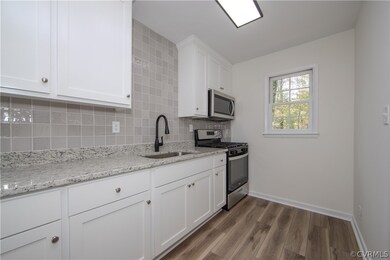 Kitchen with white cabinets, gorgeous tile backspl