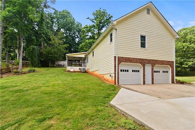 View of property exterior with an attached garage,