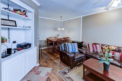 Living area with wood finished floors, ornamental