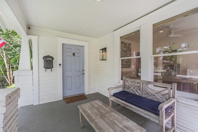 Charming front porch with views of tree lined neig