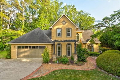 View of front of home with stucco siding, an attached garage, concrete driveway, and roof with shingles