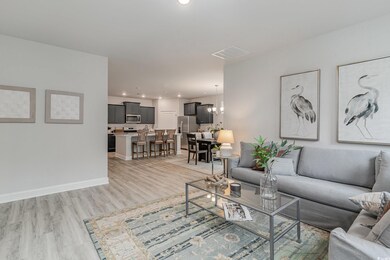 Living room featuring a notable chandelier and lig