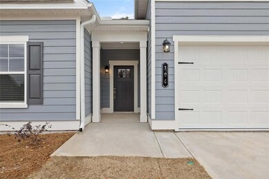 View of exterior entry with a garage