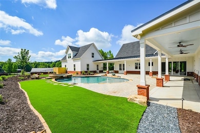 View of swimming pool with a patio area, ceiling f