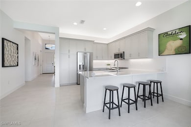 Kitchen featuring a kitchen bar, stainless steel a