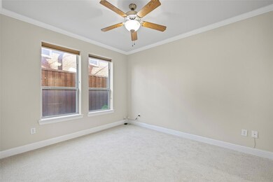 Bedroom with fresh new carpet, ceiling fan, and en