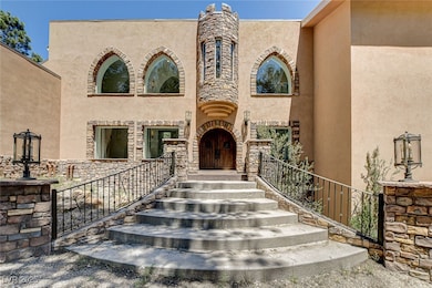 Property entrance featuring stucco siding and ston