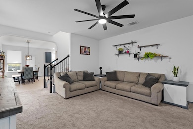Living area with light colored carpet, a ceiling 