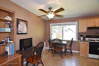 New window overlooking fenced backyard, ceiling fa
