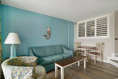 Living room featuring wood finished floors and baseboards