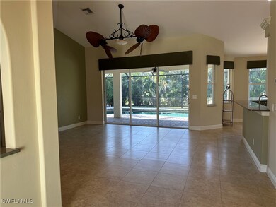 Empty room featuring baseboards, tile patterned fl