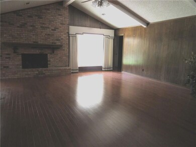 Beautiful genuine hardwoods in enormous den. Windo