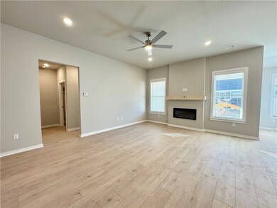 The centerpiece of the room is a beautiful electric fireplace, adding a touch of charm.
