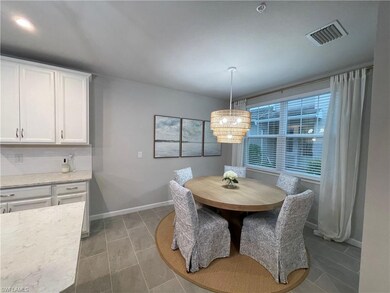 Dining space with a notable chandelier and tile pa