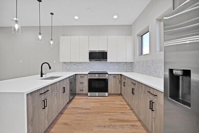 Kitchen featuring light wood-type flooring, a peni