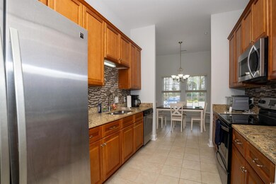 Kitchen with light tile patterned floors, stainles