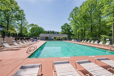 Pool with a patio and fence