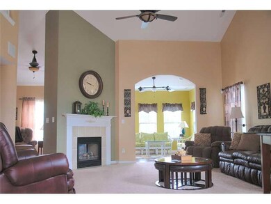 Great Room. The other end of the Great room features a 2 sided gas fireplace, walk through the arched entry to the sun room with 9 foot ceilings. Custom ceiling fan in sun room, incredible views of the back yard, patio and pond!