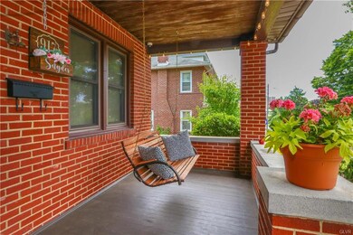 Enter under a huge front porch with swing!