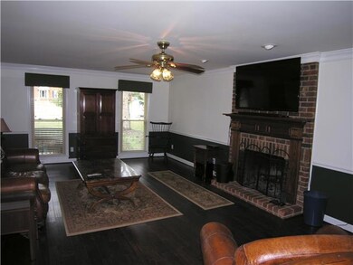 Spacious family room boasts newer wood floor, chair rail & wood burning fireplace.