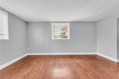 Empty room with baseboards and wood finished floors