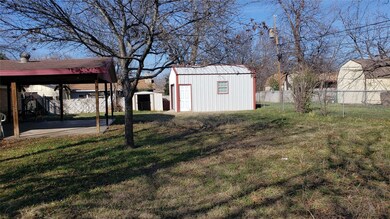 View of yard with a carport and a storage shed