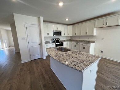 Kitchen with stainless steel microwave, an island