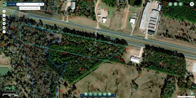 Property also includes the wooded triangular area