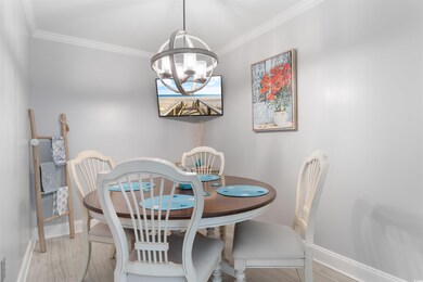 Dining space featuring a chandelier, baseboards, o