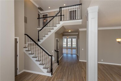 Entrance foyer featuring wood finished floors, bas