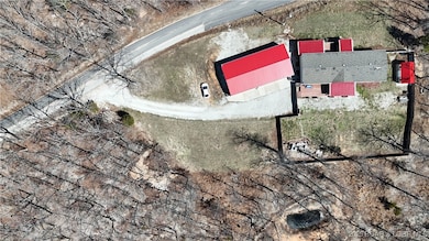Ariel shows home & garage & fenced yard