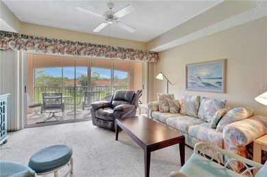 Living area featuring carpet floors, a textured ceiling, and ceiling fan