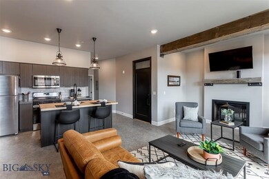 Living room featuring beamed ceiling and sink
