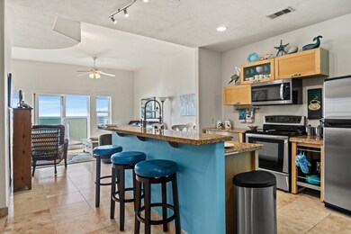 The open floor plan unit has Travertine tile, rece