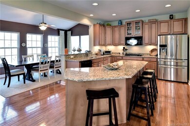 The expansive kitchen features hardwood floors, granite counters, tons of storage, pantry, gas cooking, double ovens and a light filled morning room with vaulted ceiling.