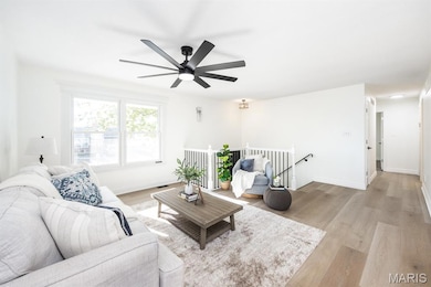 Living area with light wood-style flooring and baseboards
