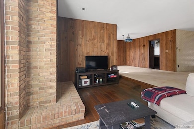 Living room featuring wood walls and dark wood-style floors