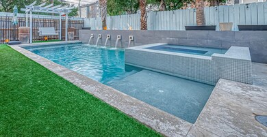 Backyard oasis with luxurious gunite pool with hot