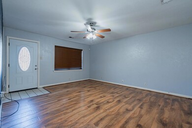 Foyer entrance with ceiling fan and dark wood-type