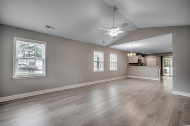 Unfurnished living room featuring lofted ceiling, 