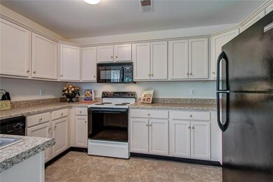 Spacious Kitchen with plenty of cabinets! Stainless steel sink. 