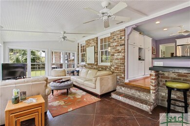 Bright, open den leads to a fenced-in backyard and