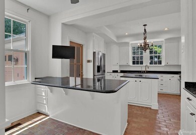 Kitchen with a breakfast bar, hanging light fixtur