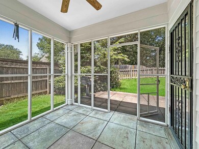 Unfurnished sunroom featuring a ceiling fan
