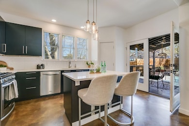 Kitchen with a sink, finished concrete flooring, 