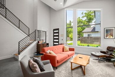 Living area featuring stairway, high vaulted ceil