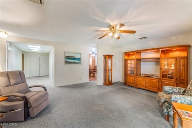 Living room with carpet, ceiling fan, and a textur