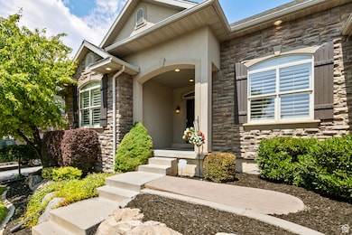 View of exterior entry featuring stone siding and stucco siding
