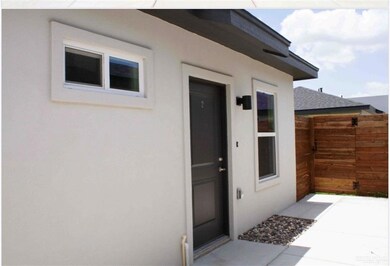 Doorway to property featuring stucco siding and a shingled roof